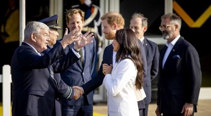 The Duke and Duchess of Sussex, Prince Harry and Meghan Markle, on the Yellow Carpet with Mayor Jan van Zanen ahead of the Invictus Games. 15 April 2022