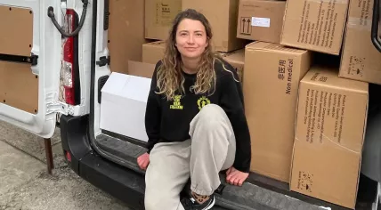 Iana Gupalova, director of Hup, sits on a van loaded with supplies. 2 April 2022