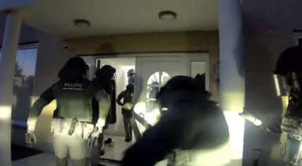 Police raiding a house in a major cocaine trafficking investigation, April 2022