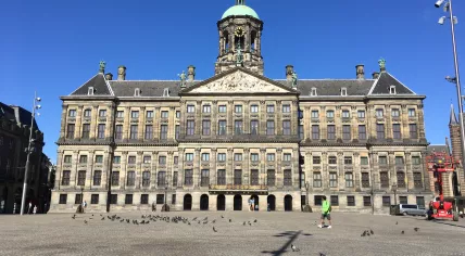 Just a handful of people on Dam Square in front of the Royal Palace in Amsterdam. May 28, 2020