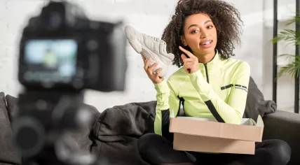 Woman filming an unboxing video