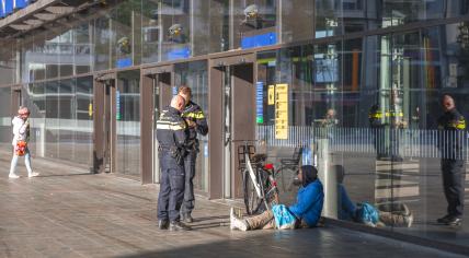 Police talking to a homeless man in front of Rotterdam Central Station, 9 October 2021