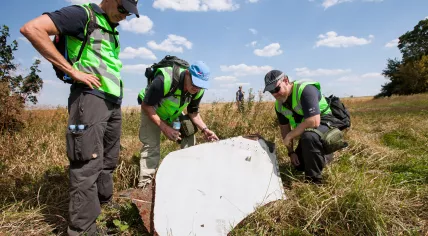 Investigation of the crash site of MH-17 by Dutch and Australian police officers.