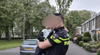 Police officer holding a 4-year-old child who caused a car accident in Utrecht on April 30, 2022.