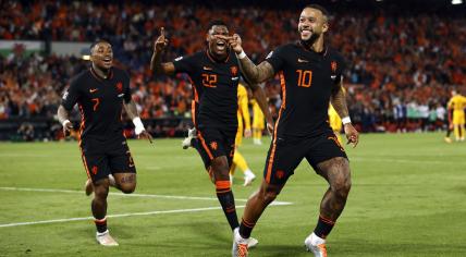 Netherlands players celebrate after scoring vs Wales