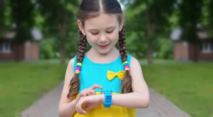 Girl uses GPS watch.