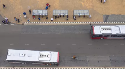 Aerial view of people waiting at a downtown bus stop in Groningen.