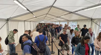 Travelers line up outside Schiphol on June 19, 2022.