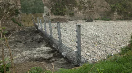 The Ocean Cleanup's Interceptor Trashfence catching plastic in the Rio Motagua in Guatemala, June 2022