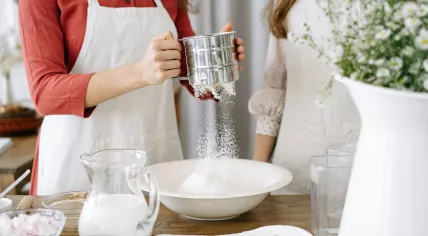 A baker and a chef working with a sieve and flour in 2020