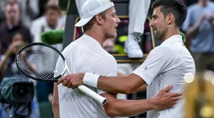 Novak Djokovic (R) of Serbia greets Tim van Rijthoven (L) of the Netherlands after Djokovic defeated van Rijthoven during their Men's fourth round match at the Wimbledon Championships, 3 July 2022