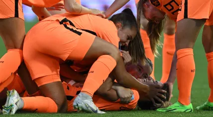 Oranje midfielder Danielle van de Donk (bottom) celebrates with teammates after scoring her team's third goal during the Euro 2022 group match against Portugal. 13 July 2022.