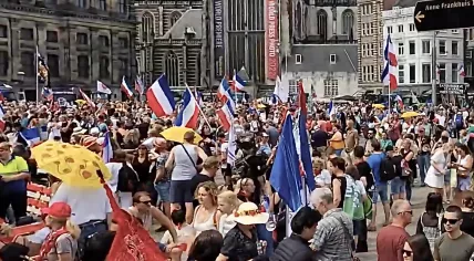 Protesters fly upside-down Dutch flags at a Dam Square rally for farmers, which also attracted many conspiracy theorists. 23 July 2022