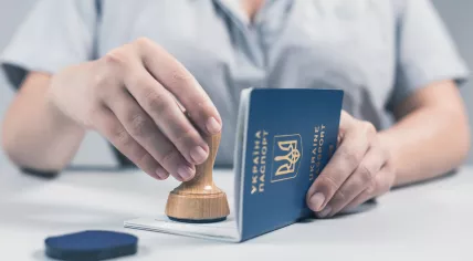 Woman stamping a Ukrainian passport