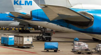 Cargo vehicles gathered below several KLM aircraft at Schiphol Airport. 21 May 2021