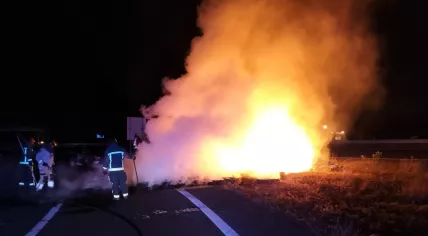 Firefighters fighting a fire set in a farmers protest on the A7 highway near Marum, 28 July 2022