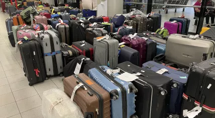 One of many piles of unclaimed luggage in one of the Schiphol Airport baggage halls. 7 Aug. 2022