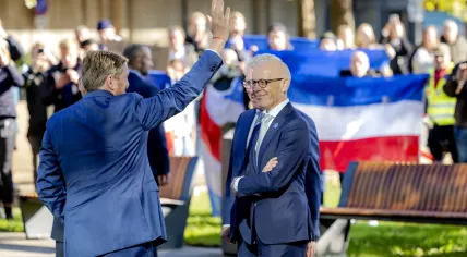 King Willem-Alexander waves at protesters heckling him as he arrives for a working visit at Radboudumc in Nijmegen, 29 September 2022
