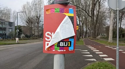 A BIJ1 election poster pasted over a PvdA poster