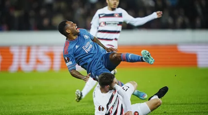 Henrik Dalsgaard of FC Midtjylland tackles Feyenoord player Danilo during a UEFA Europa League Group F match in Herning, Denmark, 6 October 2022