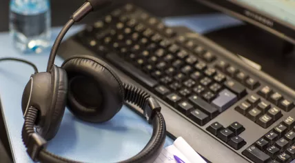 Headset with microphone and computer.