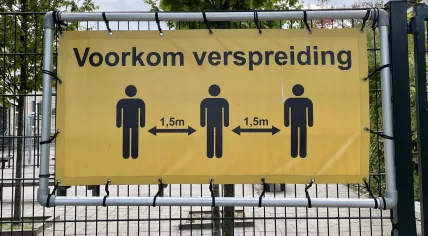 A sign encouraging the use of social distancing remained on the fence outside an Amsterdam schoolyard. 5 October 2022