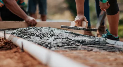 A crew working with cement at a construction site