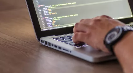 A man working on a laptop.