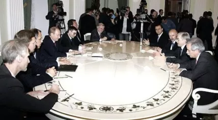 Russian President Vladimir Putin looks across the table at Rene van der Linden, while speaking as the President of the Council of Europe Parliamentary Assembly. 29 May 2006