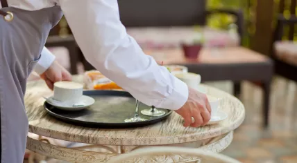Waiter clearing a table