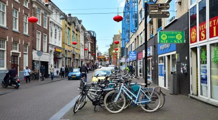 People walk along the Wagenstraat in the Chinatown neighborhood of The Hague. 8 May 2015