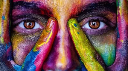 A woman's face covered in different paints