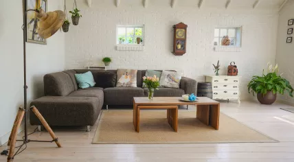 A bright, white living room with exposed beams