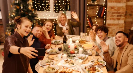 A family takes a selfie during a Christmas dinner