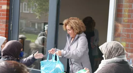 A Red Cross worker distributing food packages in Amsterdam
