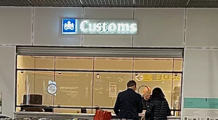 A Douane worker looking over documents at a Customs station in Schiphol Airport. 13 December 2022