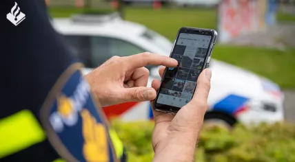 A police officer using a smartphone