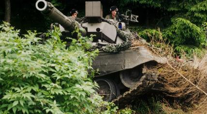 Dutch soldiers on a Leopard 1A5 tank