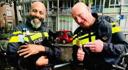 Amsterdam police officers posing with Nimis the police cat in June 2022