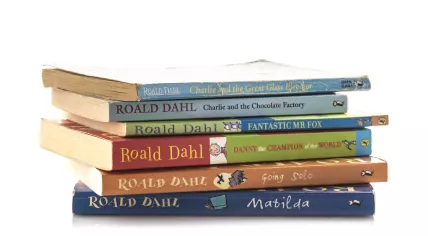 Stack of Roald Dahl books, including Charlie and the Chocolate Factory.