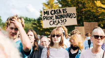 A protestor’s sign reads, “My house is Prince Bernhardt’s house?!?” referring to claims that the prince is part of a real estate investment group holding a substantial amount of housing property in the Netherlands. September 2021