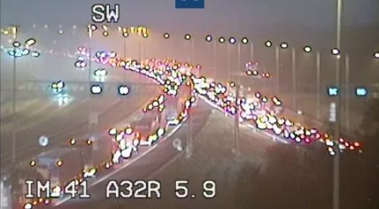 Slow moving traffic on the A28 toward Zwolle after an accident on a foggy morning, 14 February 2023