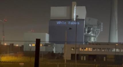 Racist text projected on the Hemweg power station in the Amsterdam Westelijk Havengebied. 14 February 2023