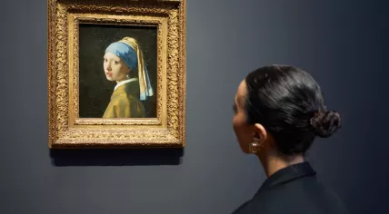 A Rijksmuseum visitor looks at Girl with a Pearl Earring at the Vermeer exhibition. February 2023