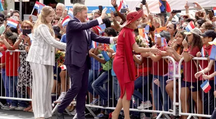 Left to right: Crown princess Amalia, King Willem-Alexander, and Queen Maxima greet a gathered crowd during a visit to Aruba, 30 January 2023