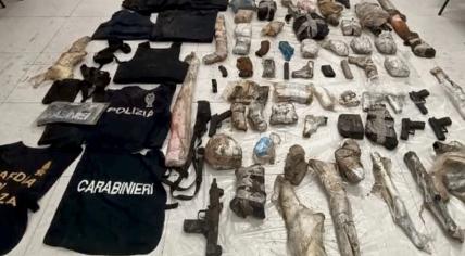 A large collection of weapons, body armor, and fake uniforms found during an investigation in Giugliano, Campania, Italy. 2 March 2023