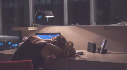Woman sleeping at a desk