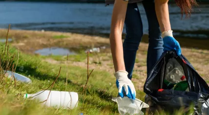 Volunteer collects plastic waste