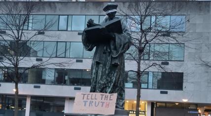 Scientist Rebellion acitivists blindfold Erasmus statue in Rotterdam