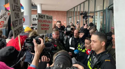 Amsterdam Mayor Femke Halsema, flanked by police officers in front of the Stopera, argues with sex workers angered about her policies regarding the Red Light District and the proposed erotic center. 30 March 2023